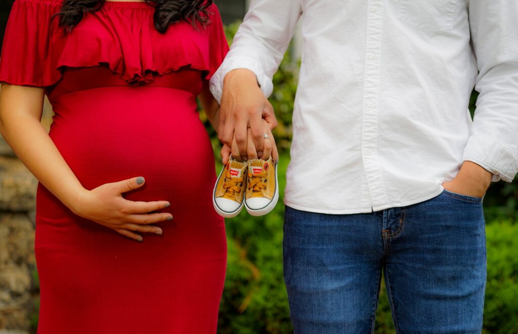 couple holding pair of brown and white low-top sneakers