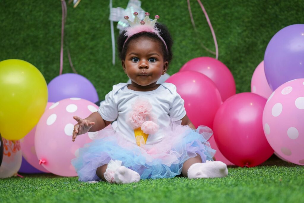 Toddler em um vestido branco com balões