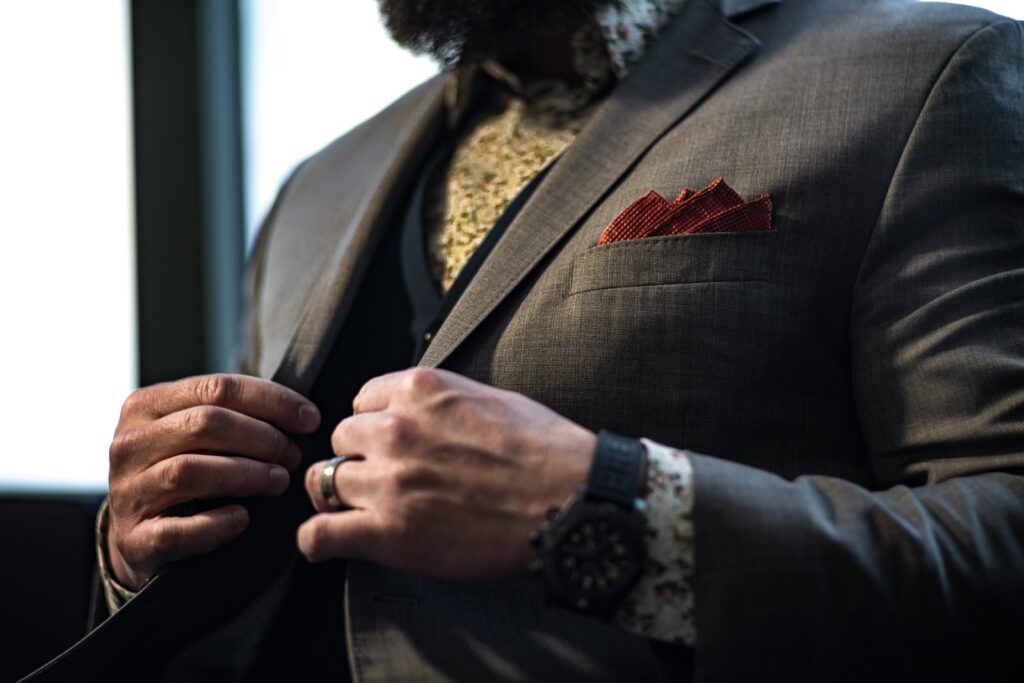 man wearing grey notched-lapel suit jacket