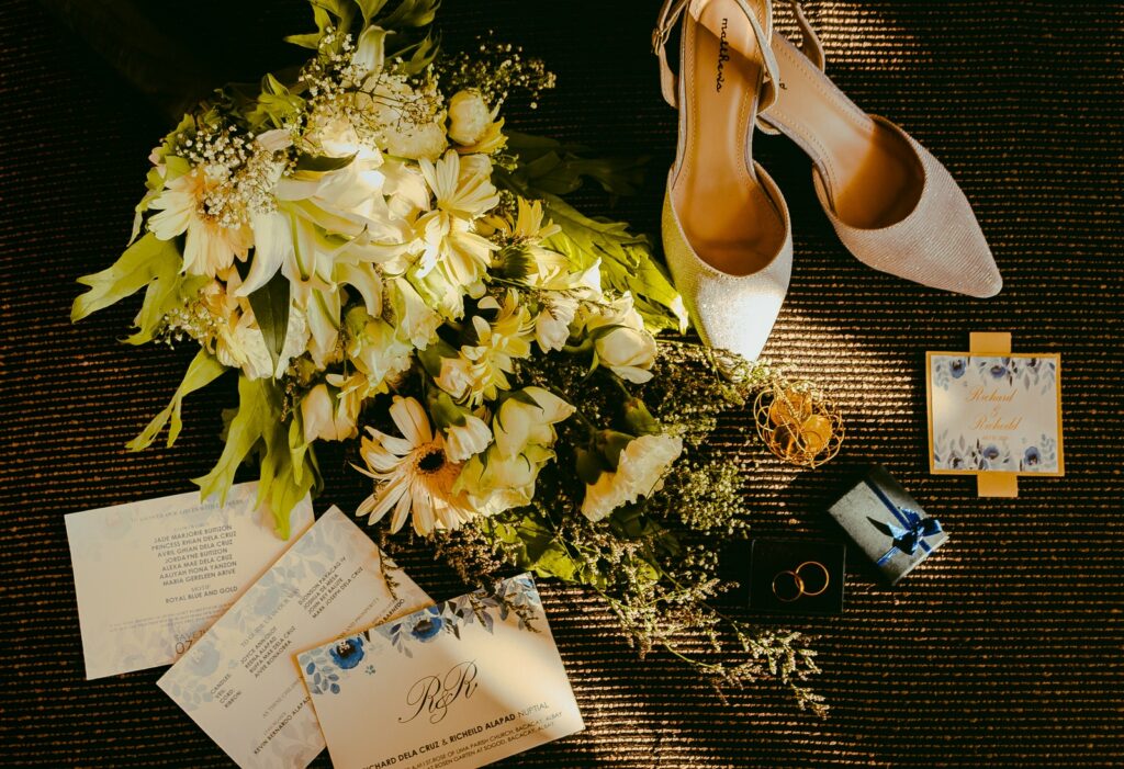 Coppia di scarpe beige accanto a un bouquet